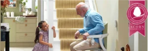 Grandfather interacting with granddaughter on a stairlift in a Somerset property