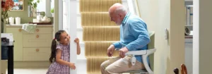 Elderly man smiling with granddaughter in a Bristol home