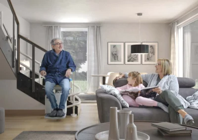 Happy grandparent simling at child and daughter using stairlift safely in a South West home